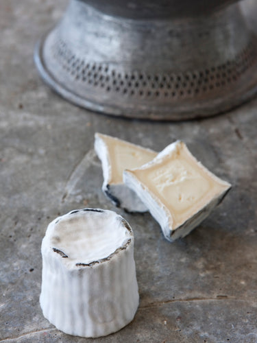 Named after its volcanic shape and ash covered rind, Vesuvius is a goat's cheese from Woodside with an ash-coated white bloomy rind. It is mild and balanced when young, with a creamy flavour that imparts a slight acidity and lively and fresh lactic nature. As it matures, the cheese starts turning firmer.