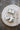 Swag Chèvre on black plate in packet and out of packet with knife, crumbling